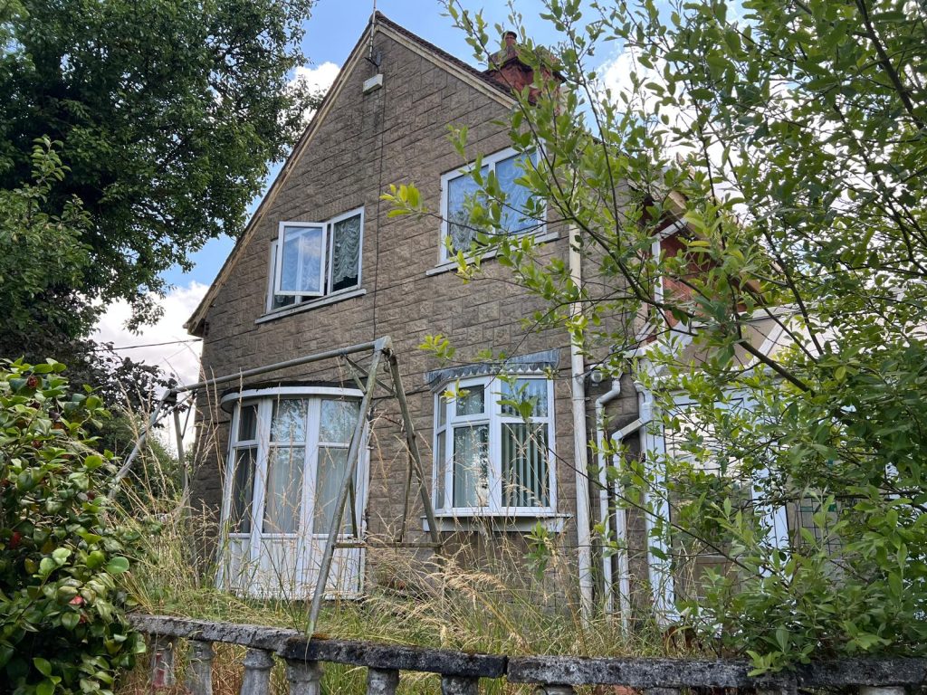 Abandoned house overgrown with plants